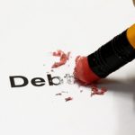 Debt being erased by the end of a pencil, word implies debt