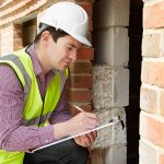 Architect Checking Insulation During House Construction